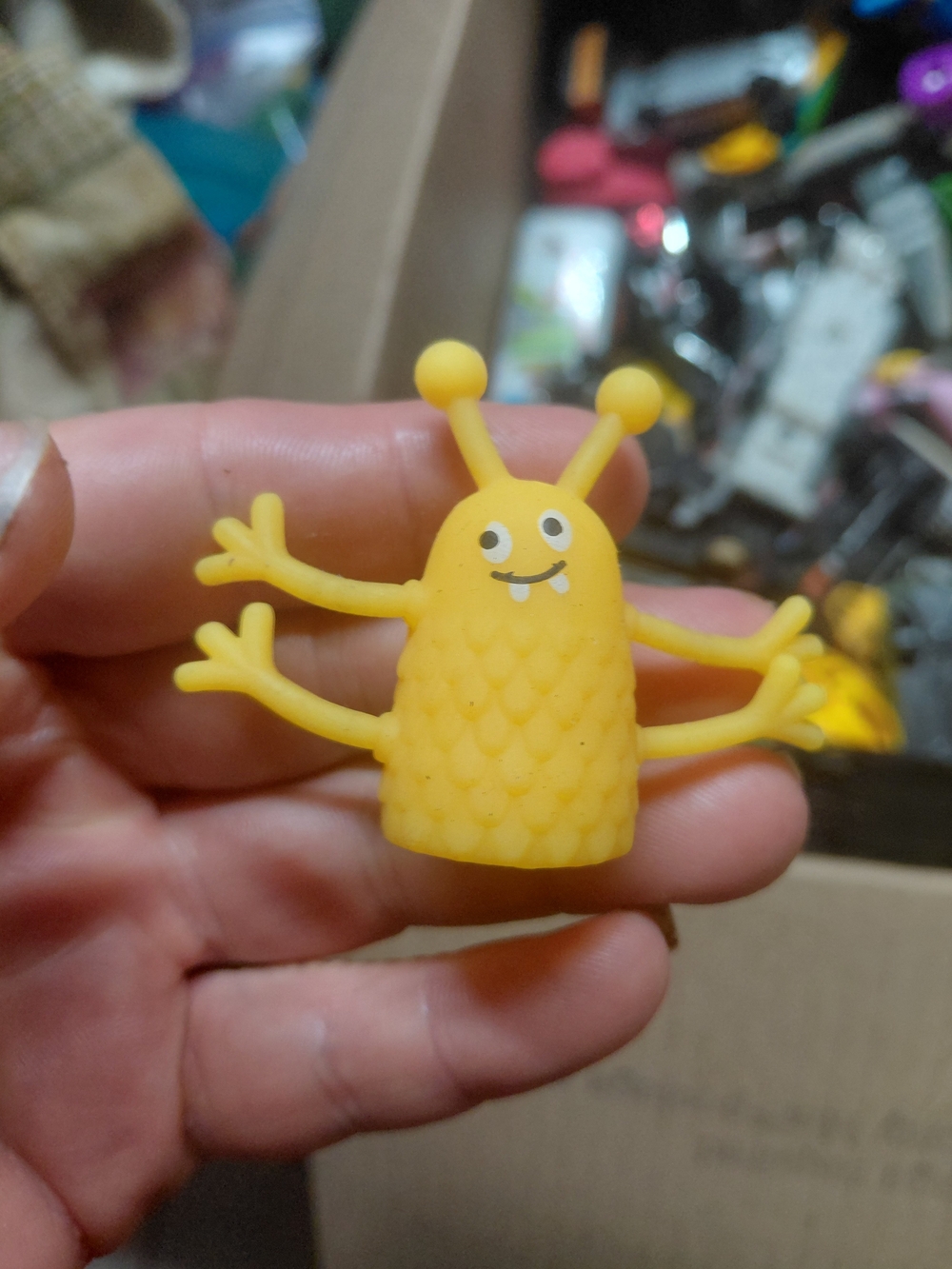 rubber alien monster finger puppet.